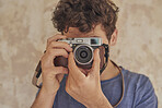 Portrait of cute sexy photographer happy man with vintage camera