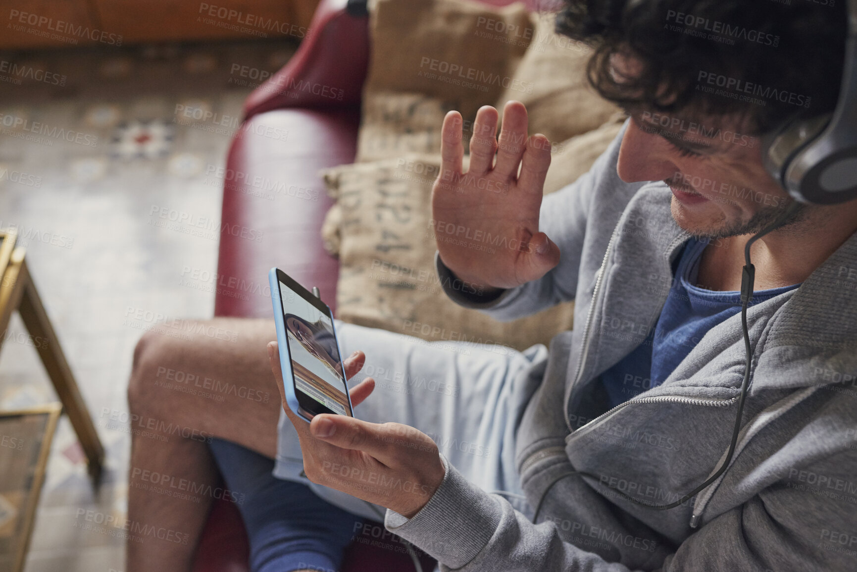 Buy stock photo Man, headphones and wave with phone screen for video call, virtual chat or connection with girlfriend. Person, contact partner or online meeting in home with tech, hello or long distance relationship