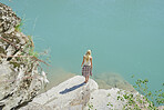 Beautiful girl exploring beautiful blue freshwater river on summer adventure vacation in nature