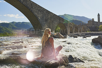 Buy stock photo Relax, travel and woman at lake on holiday, adventure and tourist trip with sightseeing view. River, female person and fresh air in nature with water, scenery and tourism landmark on vacation getaway