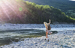 Adventure girl exploring river bank in coutryside nature travel vacation sun flare