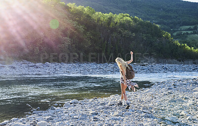 Buy stock photo Girl, back view and freedom by lake for travel, hiking and sunshine with exploring in nature. Woman, backpacking or trekking by water, summer fun and adventure in mountains for tourism outdoor