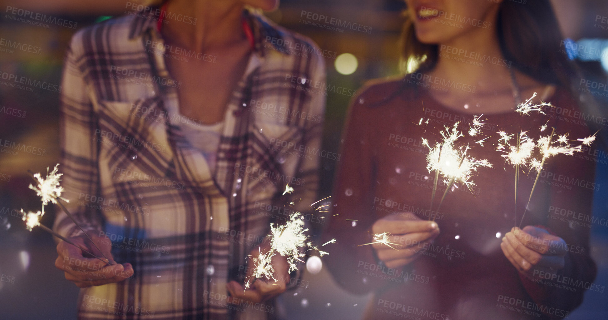 Buy stock photo Night, hands or women with fireworks for celebration, new year holiday or birthday party together. Female people, sparklers or festive season in late evening for fun event, outdoor festival or memory