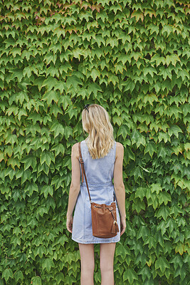 Buy stock photo Back, holiday and woman outdoor with hedge, travel and botanical landmark on adventure trip. Wall, leaves and female person in nature with tourist, green scenery and destination of vacation getaway