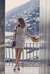 beautiful fashionable woman using smart phone technology at hotel on luxury vacation to communicate on social media