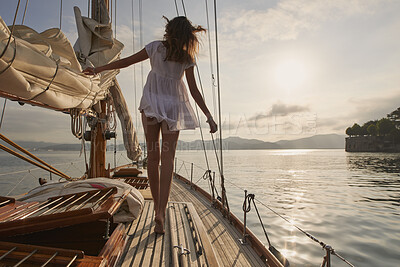 Buy stock photo Woman, sail and ocean with boat for travel, outdoor adventure or vacation journey on sea. Back view, female person or sailor with sunshine on yacht for tourism, cruise or trip on coast in nature