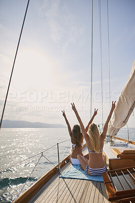 Buy stock photo Peace, travel and freedom with friends on yacht for summer vacation, suntanning and seaside adventure. Relax, sailing and tropical cruise with back of women on boat for ocean expedition and journey