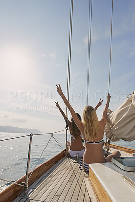 Buy stock photo Peace, travel and back with friends on yacht for summer vacation, suntanning and seaside adventure. Relax, sailing and tropical cruise with women on boat for ocean expedition, freedom and space