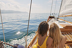 Beautiful women friends taking selfies smart phone social media on sailboat in ocean on luxury lifestyle adventure travel vacation