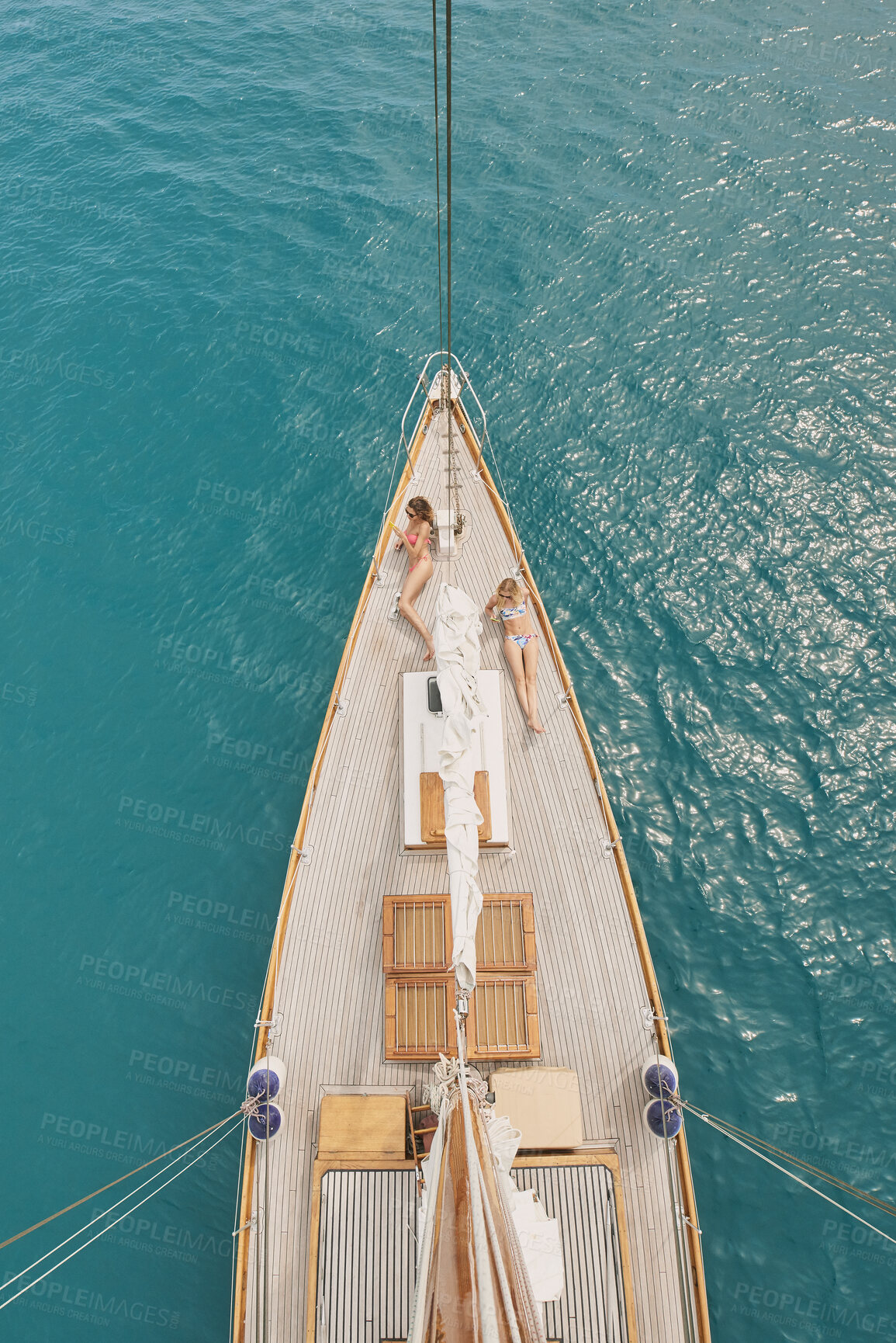 Buy stock photo Women, relax and summer holiday in ocean with boat, travel or chill outdoor on deck for luxury getaway. Above, friends rest and journey at sea with yacht, adventure and bonding together for vacation.