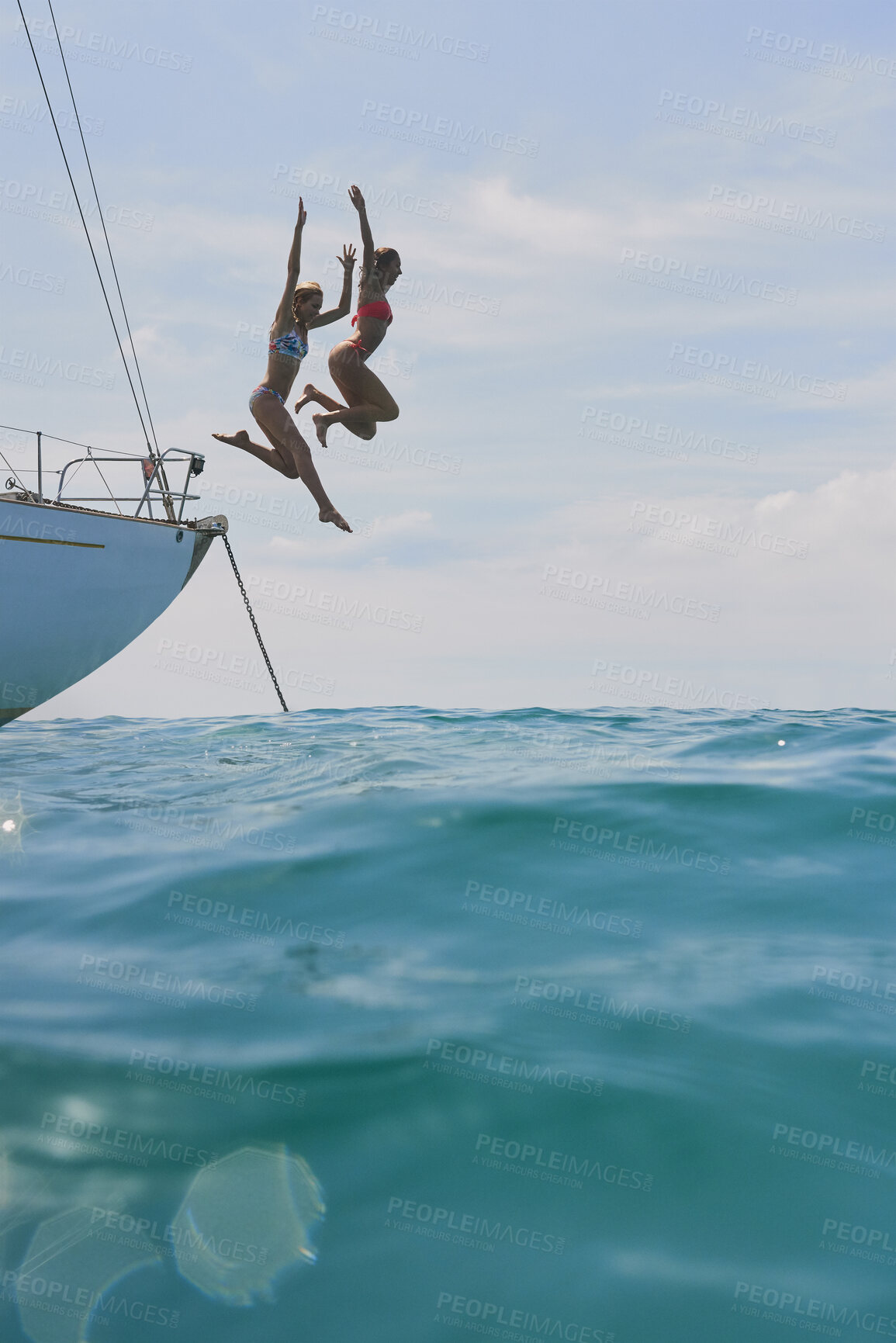 Buy stock photo Freedom, jump and ocean with friends on yacht for summer vacation, seaside getaway and energy. Holiday cruise, bonding and sailing with women on boat for tropical journey, space and travel on sea