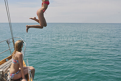 Buy stock photo Jump, freedom and holiday with friends on yacht for summer vacation, diving and sea adventure. Swimming, sailing and tropical cruise with women on boat for ocean expedition, energy and space