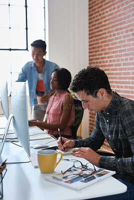 Buy stock photo Graphic design, drawing and man in office with notebook, illustration and sketch for animation. Artist, coworking and writing in workplace with tech, cartoon character and creative art for production