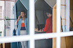 Young business people working in colorful office cubicles in workplace