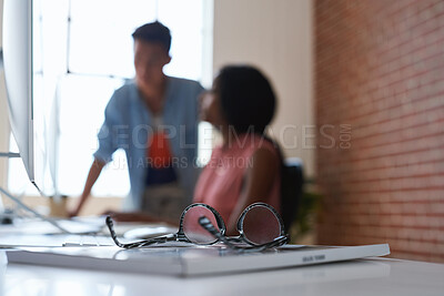 Buy stock photo Design, glasses and textbook on office desk with business discussion of people for planning. Collaboration, conversation and eyewear on table in creative workplace for designer feedback or meeting