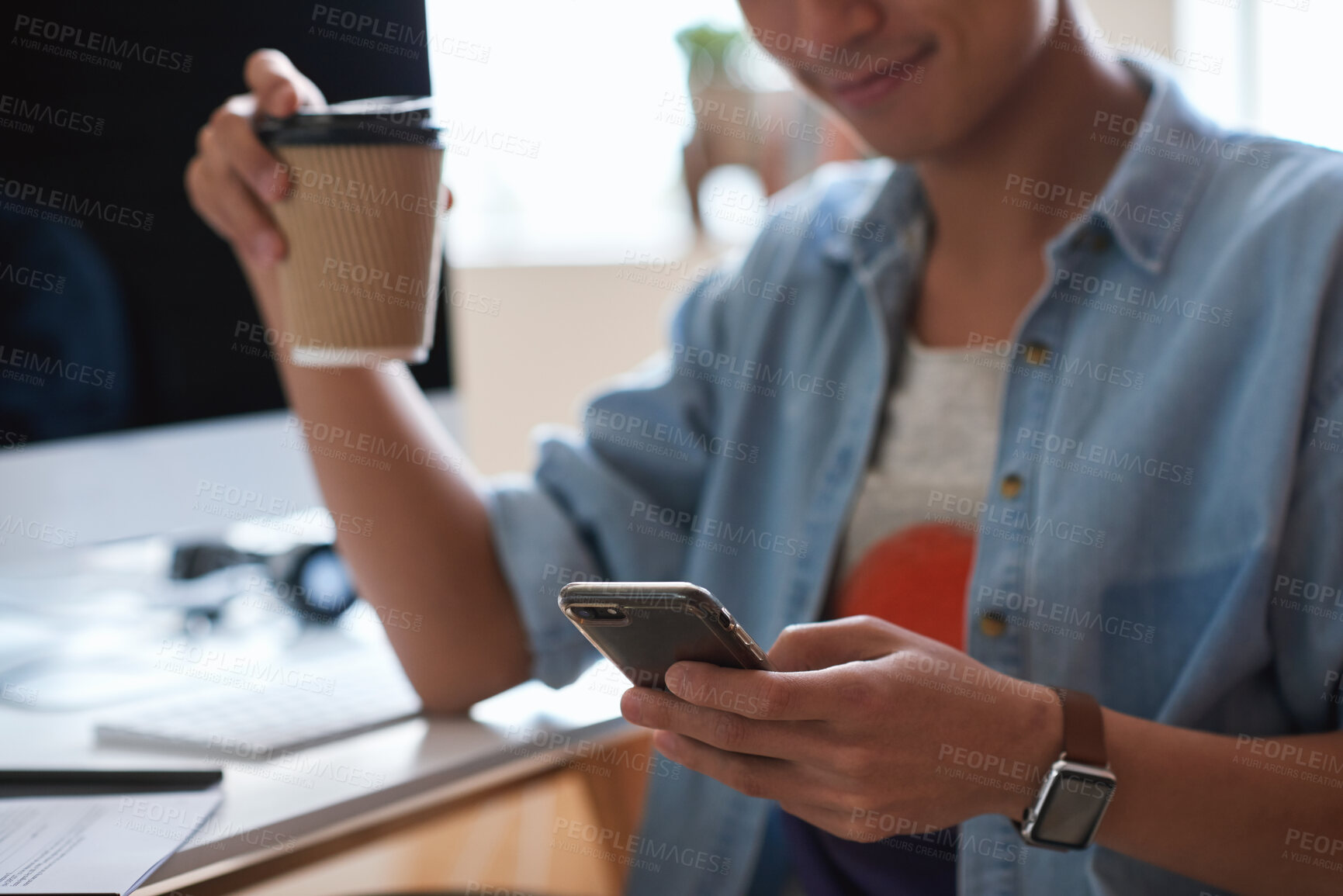 Buy stock photo Coffee, hands and phone with designer man at desk in office for communication, report or research. App, takeaway drink and typing with design employee at work for chatting, feedback or mobile update