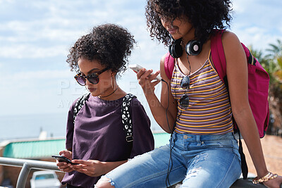 Buy stock photo Digital, streaming or college students outdoor with phone, video scroll or message update in online chat. Friends, space or people with tech, app browsing or social media comments on university post.