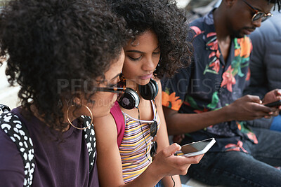 Buy stock photo Phone, friends and people outdoor for social connection, online fashion and show music playlist. Gen z students, mobile and women hangout with audio app, streetwear and share podcast info on internet