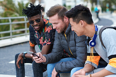 Buy stock photo Phone, friends and men outdoor for social connection, funny meme and show music playlist on internet. Group, mobile and happy people hangout with audio app, laughing and share joke online in city