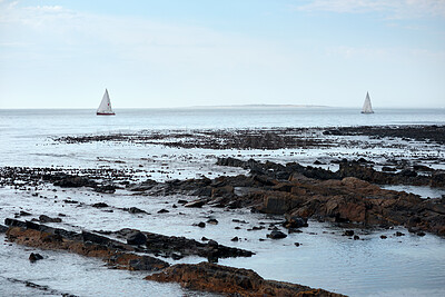 Buy stock photo Blue sky, horizon and yacht with view of ocean from seaside for holiday, travel or vacation. Clouds, rocks and seascape with boats on water for adventure cruise, getaway or voyage in morning