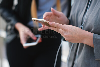 Buy stock photo Phone, friends and hands outdoor for social media, music and browsing playlist on internet. Connection, mobile and women hangout together with audio app, earphones and streaming podcast online