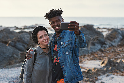 Buy stock photo Selfie, travel and couple by beach on holiday, getaway or weekend trip together for bonding. Happy, memory and interracial people with photography picture for social media by ocean on vacation.