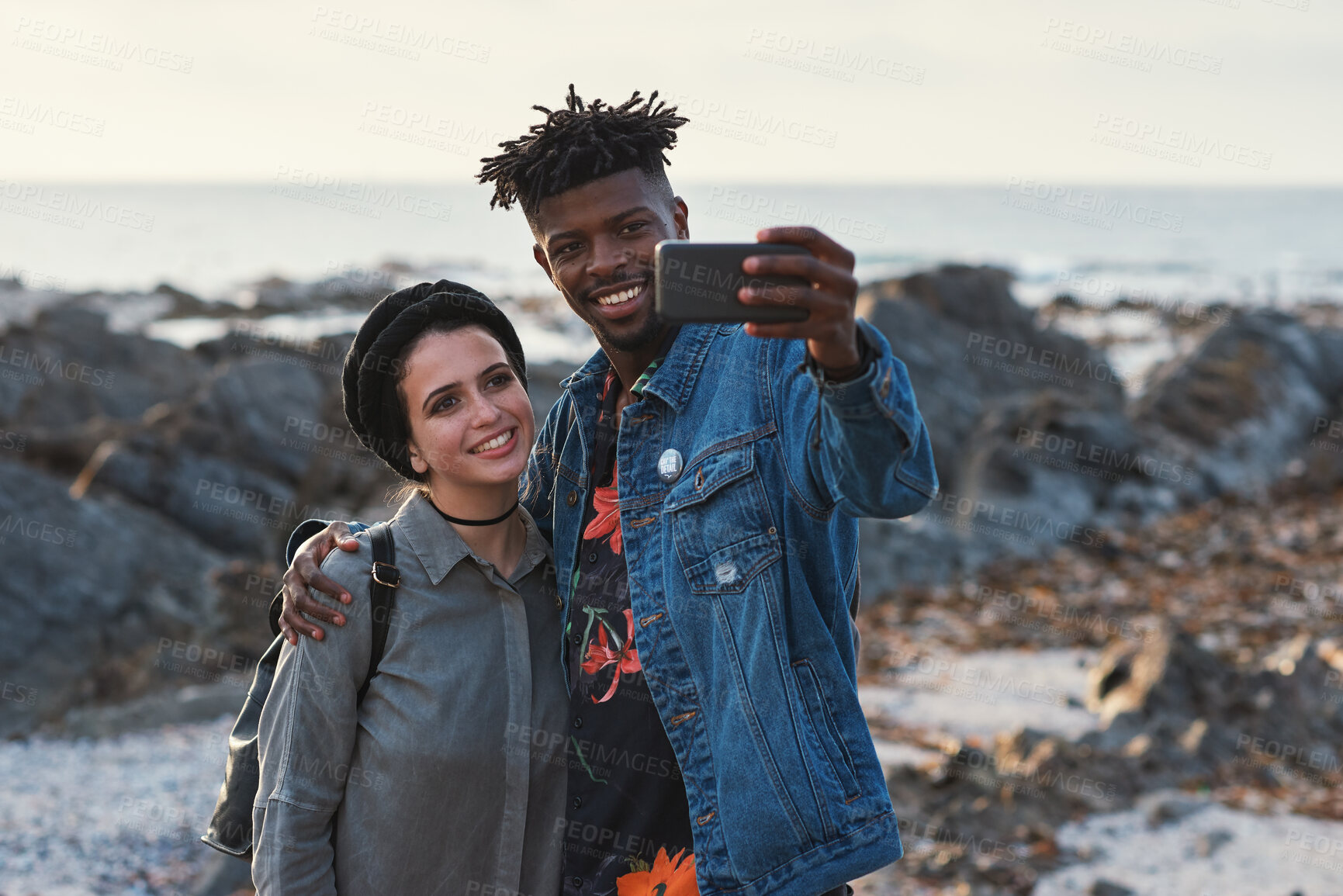 Buy stock photo Selfie, travel and couple by beach on holiday, getaway or weekend trip together for bonding. Happy, memory and interracial people with photography picture for social media by ocean on vacation.
