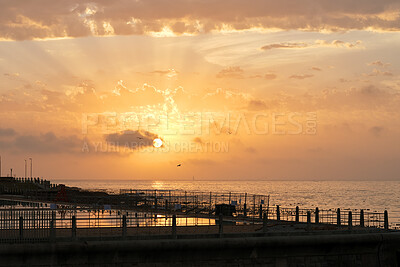Buy stock photo Clouds, space and sunset with pier at ocean for natural background or scenic wallpaper. Evening, horizon and sky with seaside boardwalk or jetty outdoor in nature for dusk and twilight scenery
