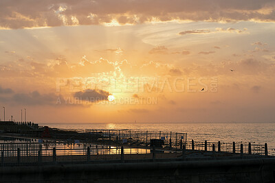 Buy stock photo Clouds, sky and sunset with pier at ocean for natural background or scenic wallpaper. Evening, horizon and space with seaside boardwalk or jetty outdoor in nature for dusk and twilight scenery