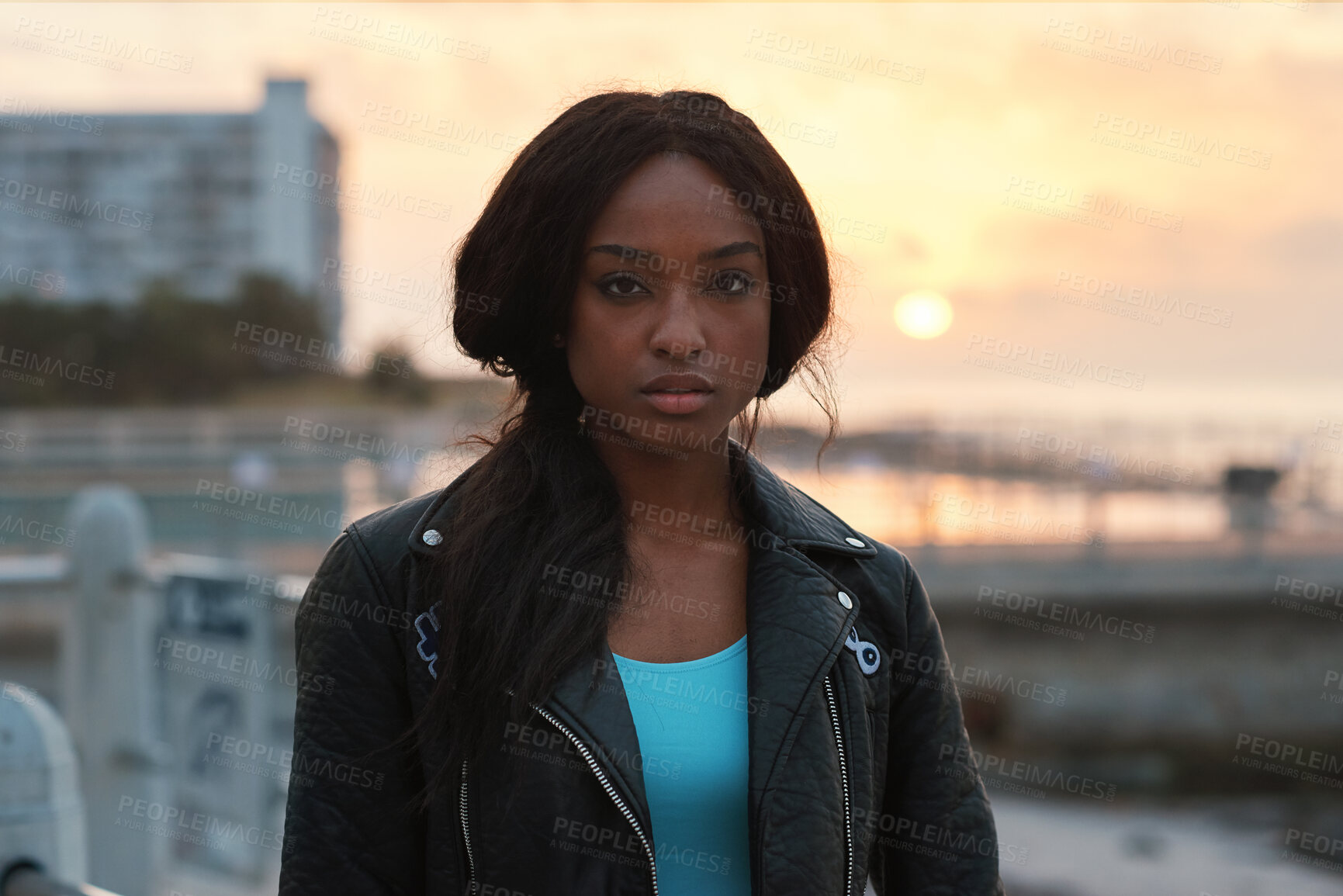 Buy stock photo Black woman, portrait and travel by beach with sunset, serious expression or trip abroad. Female traveler, nature or twilight with summer sky, vacation and person outdoor for exploring on holiday