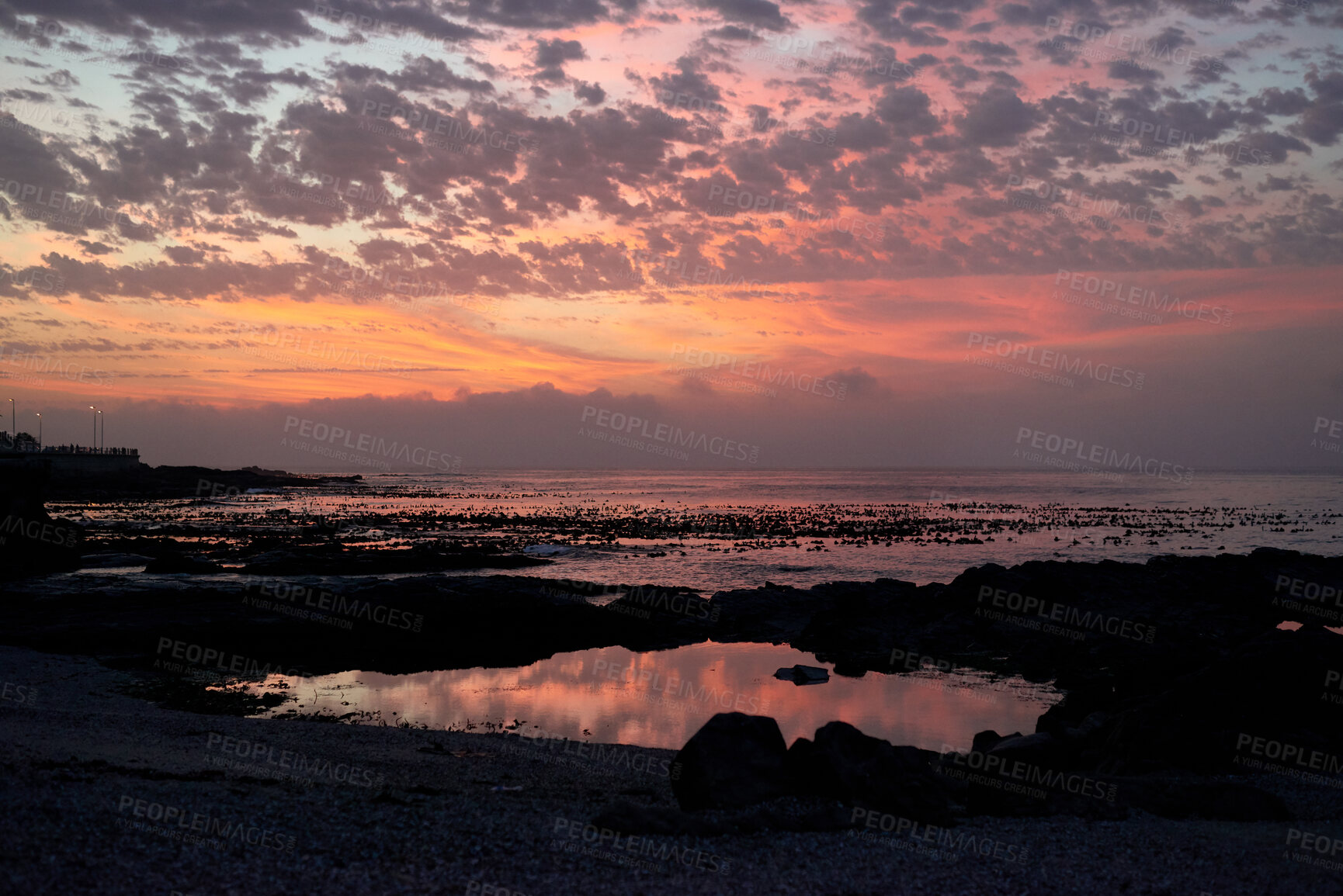 Buy stock photo Rocks, space and sunset with view of ocean from seaside for background or scenic wallpaper. Clouds, seascape and sky with water in colorful environment for calm dusk, nightfall or twilight scenery