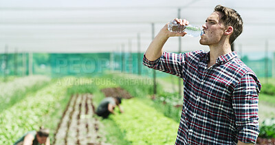 Buy stock photo Man, farmer or drinking with water in greenhouse for agriculture or natural sustainability. Thirsty, male person or farming with liquid or food production for hydration, agro business or conservation