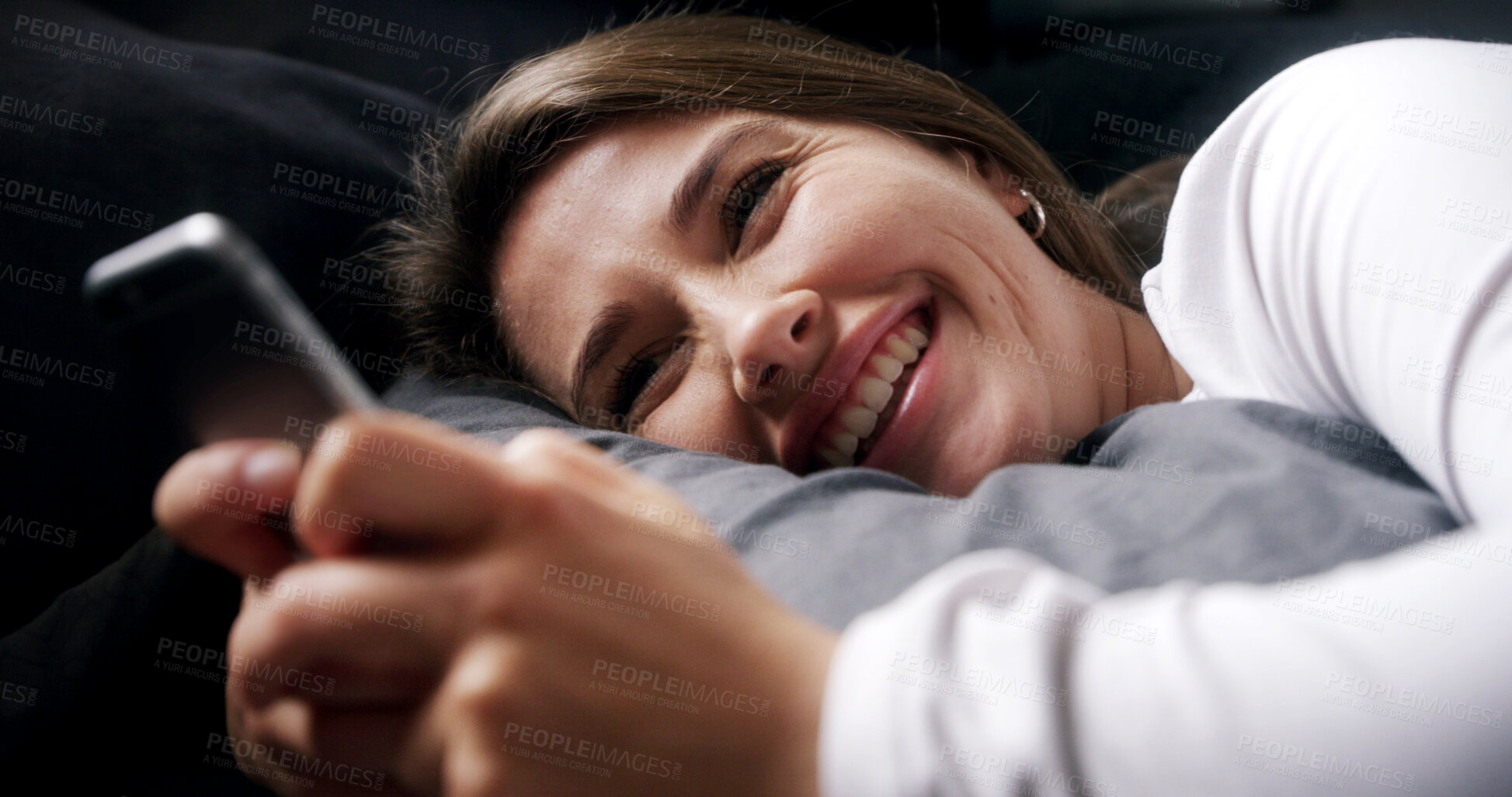 Buy stock photo Laugh, relax and woman in bed with phone, text or reading funny meme on social media in home. Smile, chill or person in bedroom on mobile app for typing message, morning notification or communication
