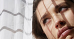 Woman, window and thinking in home with anxiety, loneliness or regret with reflection for decision. Sad, memory and person with depression with loss, grief and mental health for morning in house