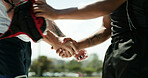 People, sport and handshake with team for match, good game or thank you on outdoor pitch. Active, athlete or players shaking hands with opponent for sportsmanship, gratitude or competition together