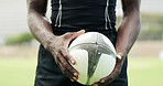 Rugby, exercise and hands of man with ball on field for tournament match, energy and competition. Sports, athlete and player with training, workout and fitness for practice, performance or contest