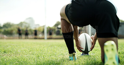 Buy stock photo Rugby ball, hands and player on field with kick, start game or match for competition or challenge. Sport, person and football on tee for tournament, score or accuracy practice with fitness and space
