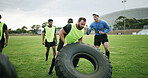 Fitness, coach and people with tire on field, strength challenge and training for sport competition. Coaching, trainer and rugby players with exercise for muscle development, active and weightlifting