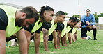 Rugby, team and push up on field with coach, shout instructions and workout for tournament practice. Sports, manager scream and people outdoor on grass with training, exercise and fitness challenge.