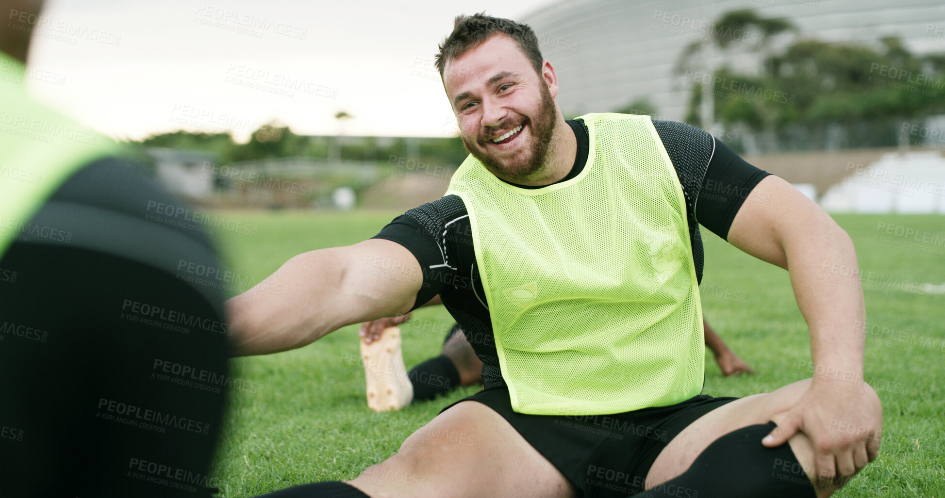 Buy stock photo Stretching, team and man with smile on field, sports training and warm up routine for preparation. Outdoor, players or people with leg exercise for mobility, fitness or rugby club for practice game