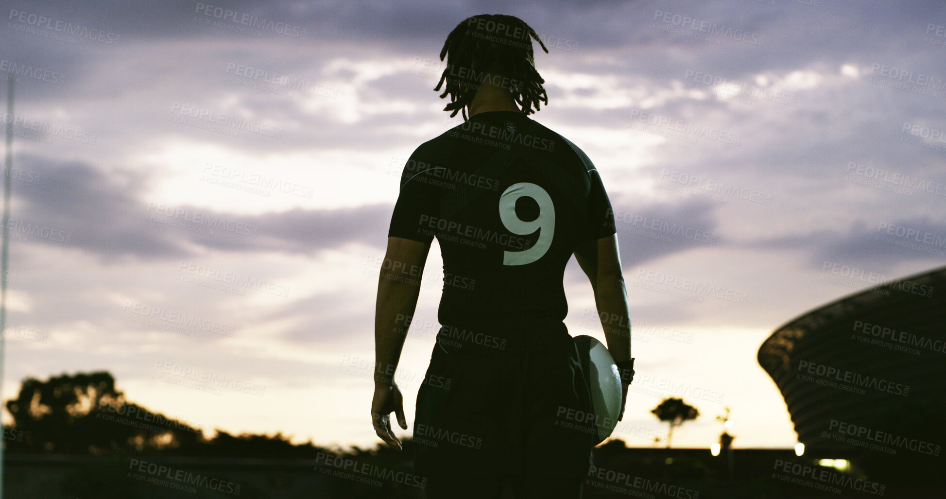 Buy stock photo Rugby, thinking and man outdoor with ball, goal mindset and daydreaming in fitness hobby. Sunset, back and player with space, athlete reflection and performance perspective in collision sport.