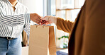 Shopping bag, purchase and hands of worker with woman in store for luxury brand purse. Discount, checkout and fashion employee with female customer for giving gift with sale or promotion in boutique.
