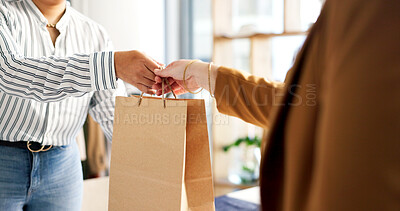 Buy stock photo Shopping bag, purchase and hands of worker with woman in store for retail offer. Discount, checkout and fashion employee with female customer for giving gift with sale or promotion in boutique.