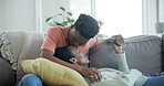 Couple, relax and holding hands on couch with kiss, commitment and bonding together for connection. Happy, black people and dating with love for caring relationship, loyalty and affection in house.