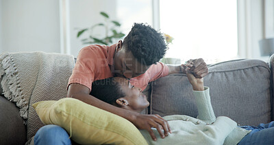 Buy stock photo Couple, relax and holding hands on couch with kiss, commitment and bonding together for connection. Happy, black people and dating with love for caring relationship, loyalty and affection in house.