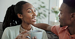 Happy, couple and conversation in home with coffee, connection and love bonding together in morning. Black people, dating and discussion in living room with tea, gossip and relationship commitment.