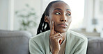 Thinking, doubt and black woman on sofa in home with bad memory, reflection or nostalgia in living room. Decision, planning and African female person with guess, worry or fear for news in apartment.