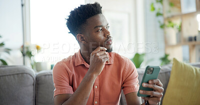 Buy stock photo Thinking, cellphone and black man on sofa in home with networking, connection or texting on mobile app. Relax, decision and African person with phone for chatting, communication or social media.
