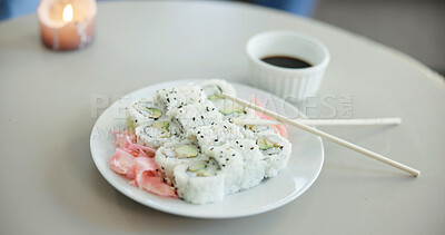 Buy stock photo Food, chopsticks and sushi on plate for dinner, Japanese cuisine or soy sauce to enhance flavor. Meal, rice or pickled ginger on dish for appetizer, seafood catering and nutrition with candle in home