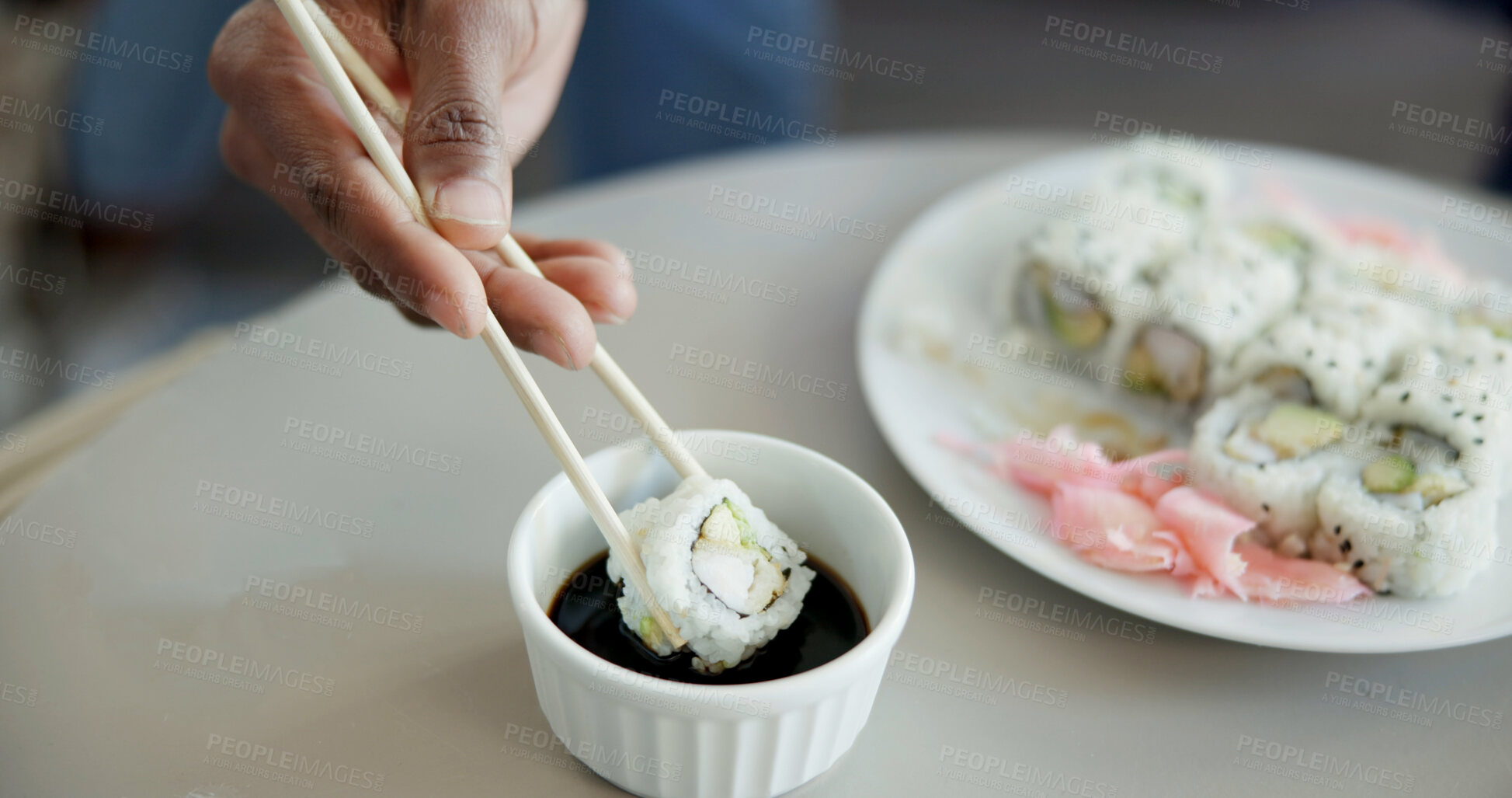 Buy stock photo Hand, chopstick or sushi in home for dinner, Japanese cuisine or roll selection in living room. Hungry person, rice meal or soy sauce in dish to enhance flavor, seafood catering or platter in house